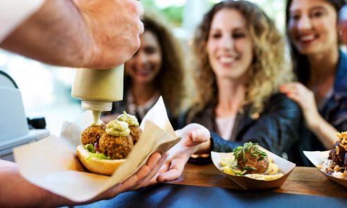 portrait-three-beautiful-young-women-buying-meatballs-food-truck-park-scaled
